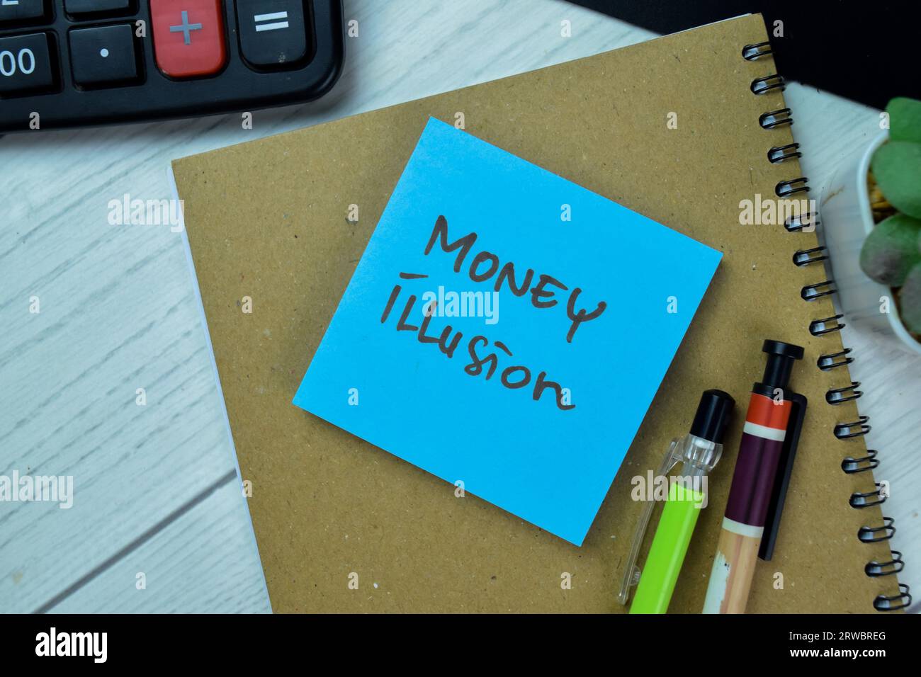 Concept of Money Illusion write on sticky notes isolated on Wooden Table. Stock Photo