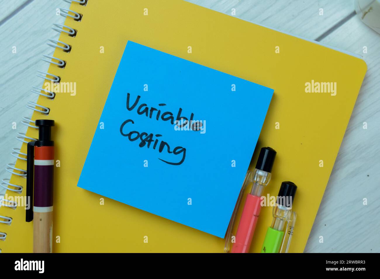 Concept of Variable Costing write on sticky notes isolated on Wooden Table. Stock Photo