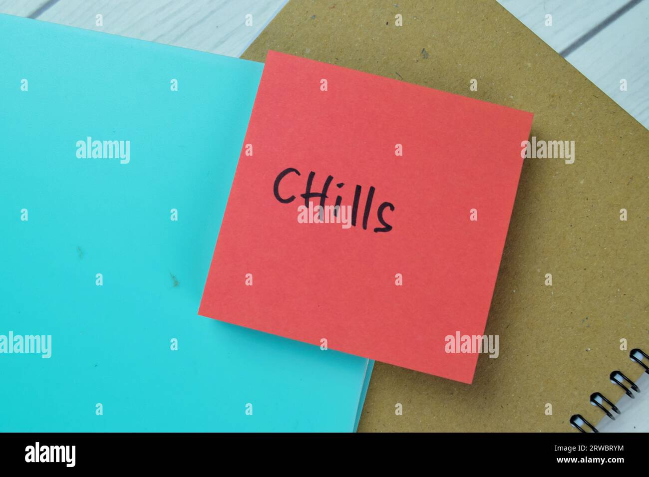 Concept of Chills write on sticky notes isolated on Wooden Table. Stock Photo