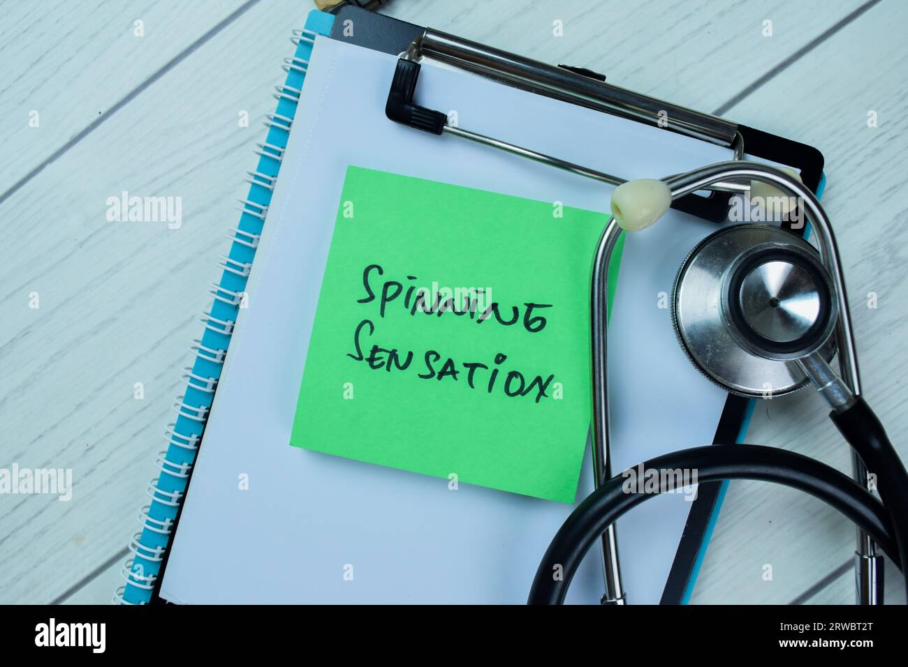 Concept of Spinning Sensation write on sticky notes with stethoscope isolated on Wooden Table. Stock Photo