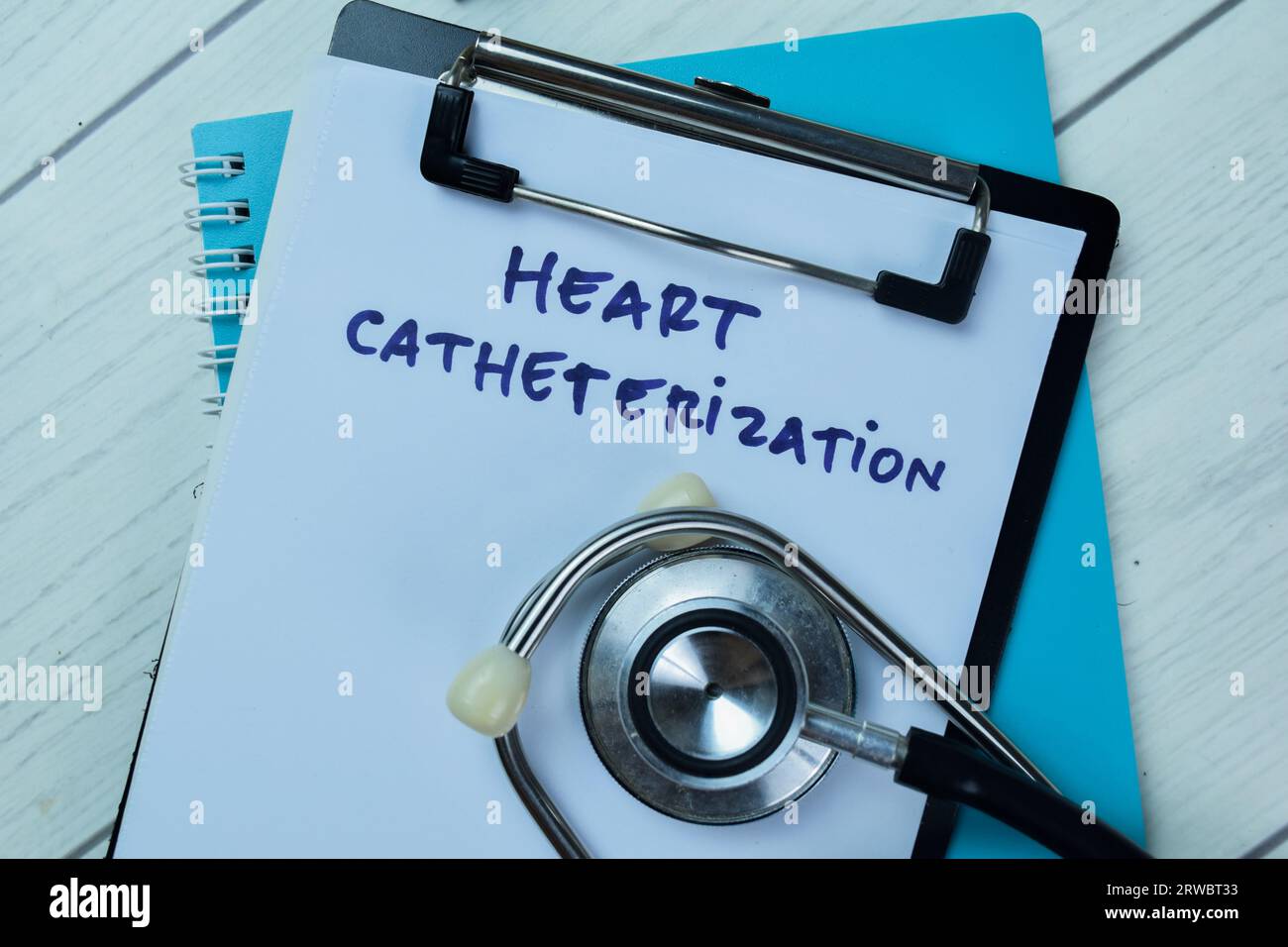 Concept of Heart Catheterization write on paperwork with stethoscope isolated on Wooden Table. Stock Photo