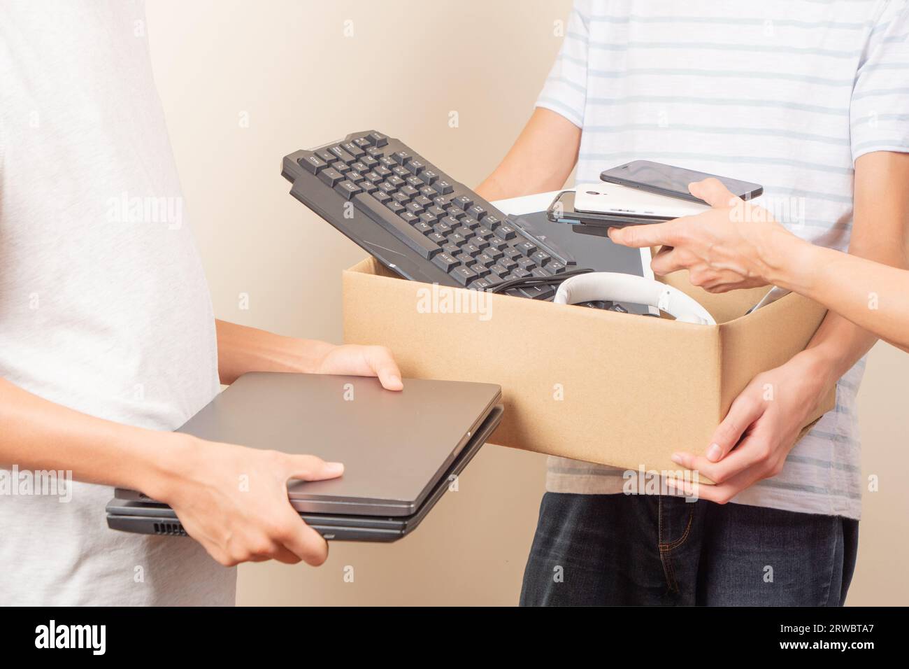 Volunteer collecting used technology gadgets to charity. Donation box