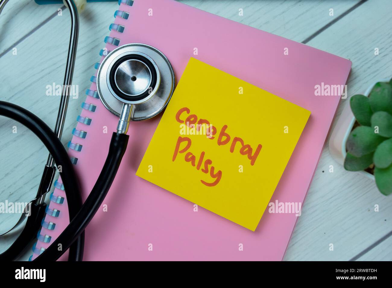 Concept of Cerebral Palsy write on sticky notes with stethoscope isolated on Wooden Table. Stock Photo