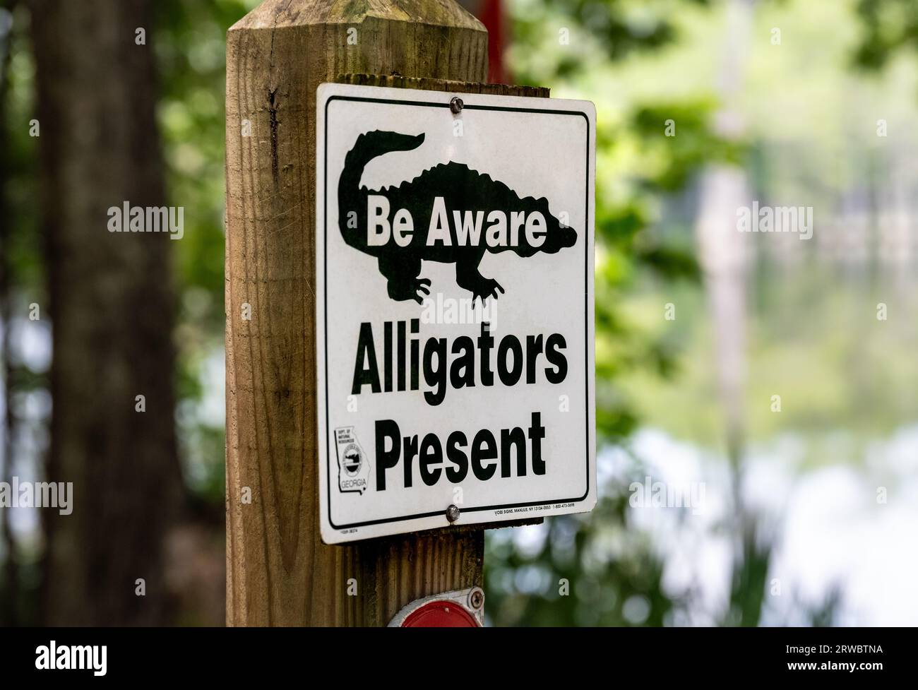 Alligator awareness sign at George L. Smith II State Park, popular for its submerged cypress forest kayak trails, in Twin City, Georgia. (USA) Stock Photo
