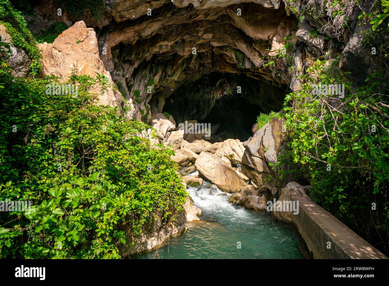 From above transparent clear rippling river water flowing through rocky rough cave called Cueva del gato inBenaoján, Malaga, Spain Stock Photo