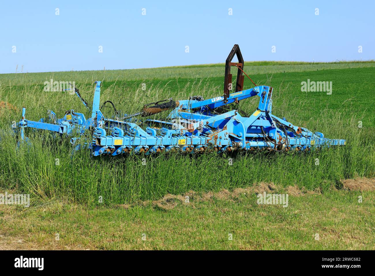 Agricultural equipment has grown into grass Stock Photo Alamy