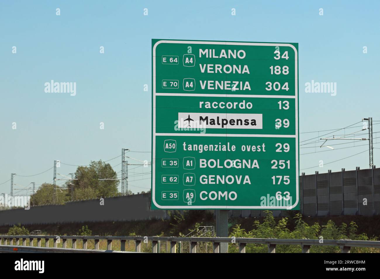 road sign on the motorway with the names of important Italian cities and directions to the MALPENSA airport in Milan Stock Photo