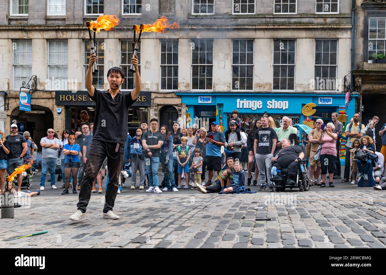 Street performer juggling fire torches, Edinburgh Festival Fringe, Royal Mile, Scotland, UK Stock Photo