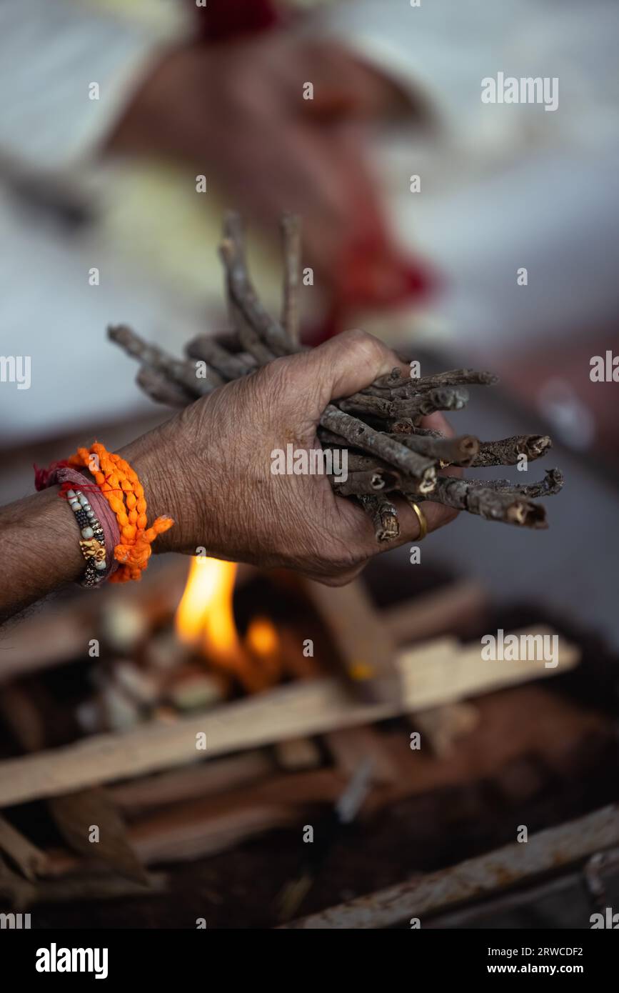 During an Indian wedding, a priest performs a ritual with fire and wood ...