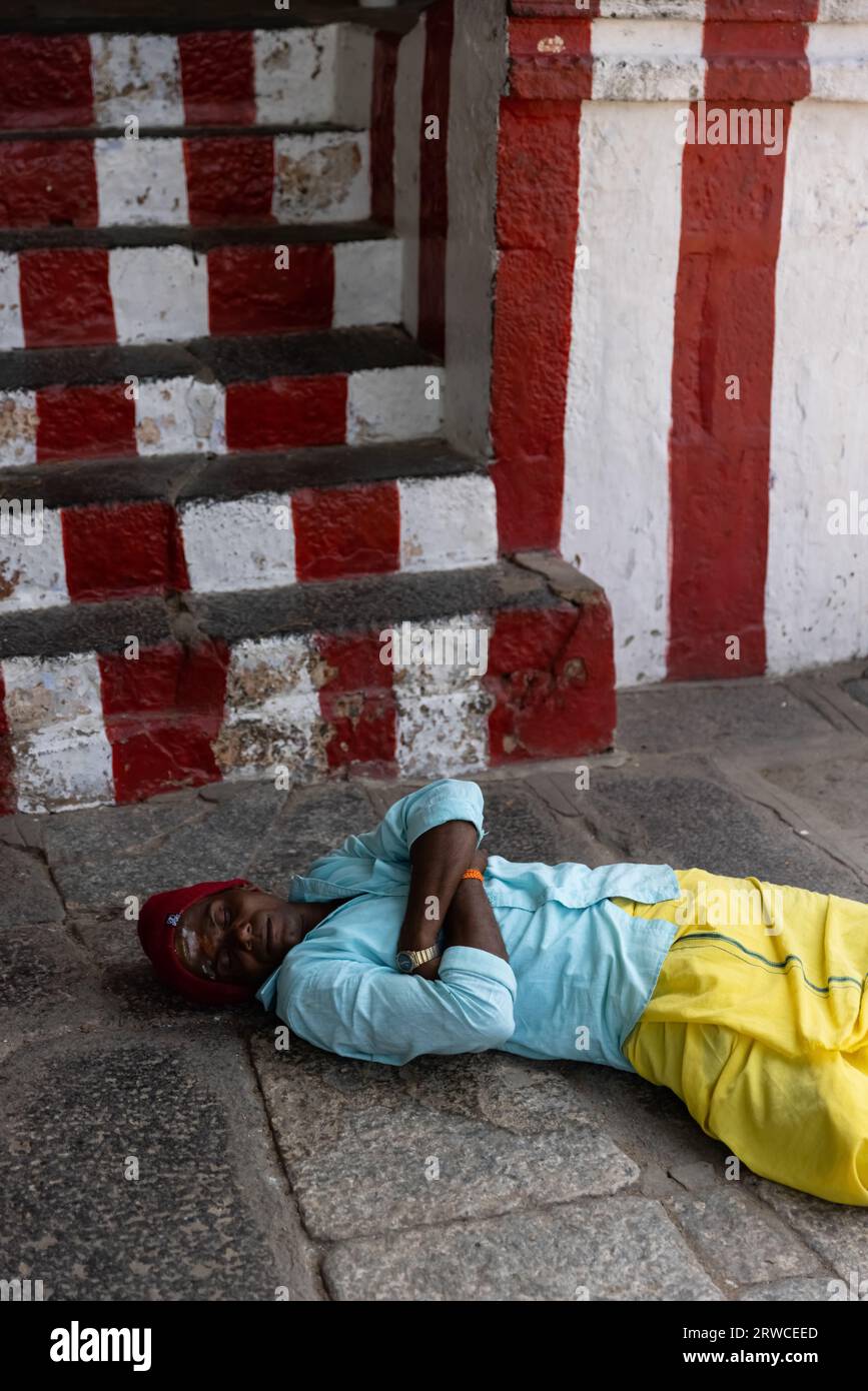 January 11, 2023, in South India, pilgrim sleep in an ancient Hindu temple during the day time. High quality photo Stock Photo
