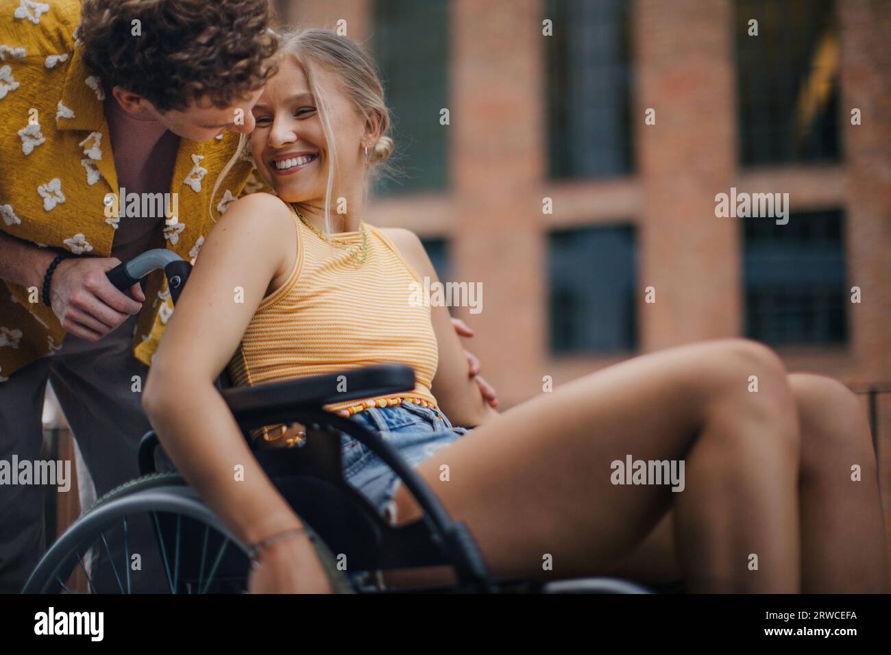 Beautiful gen Z girl in a wheelchair with her boyfriend Stock Photo - Alamy