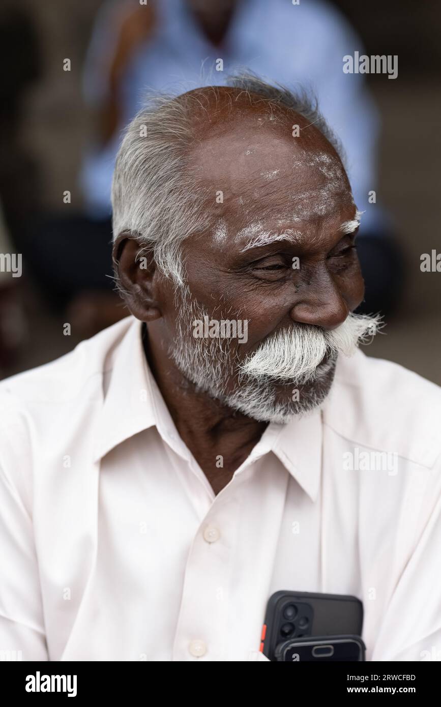 India, Delhi, January 7, 2023. Portrait of a mature Indian man, 45 years old, with gray hair and mustache on the street. He is in good spirits. Stock Photo