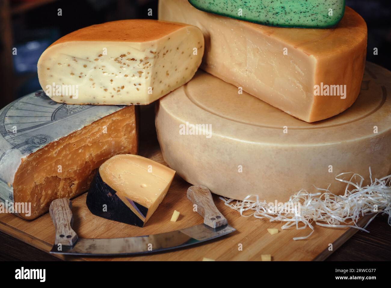 close-up of cheese heads, chopped heads, pieces of , knife with , cheese on the shelves Stock Photo