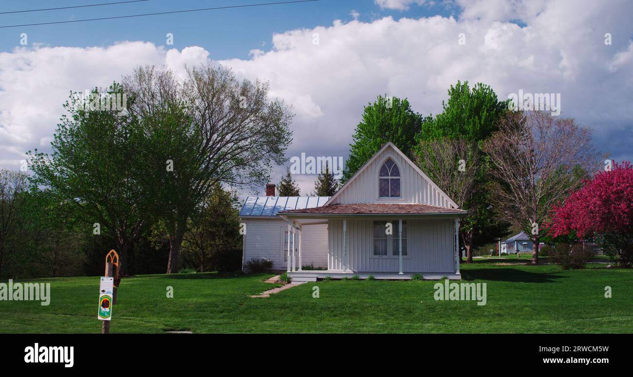 Facade of the famous American Gothic house with signage on a perfect spring day in Iowa. Stock Photo