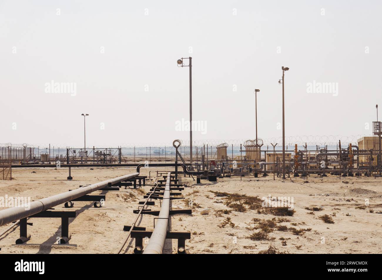 a natural gas pipeline runs across desert sand in the Middle Eastern state of Bahrain Stock Photo