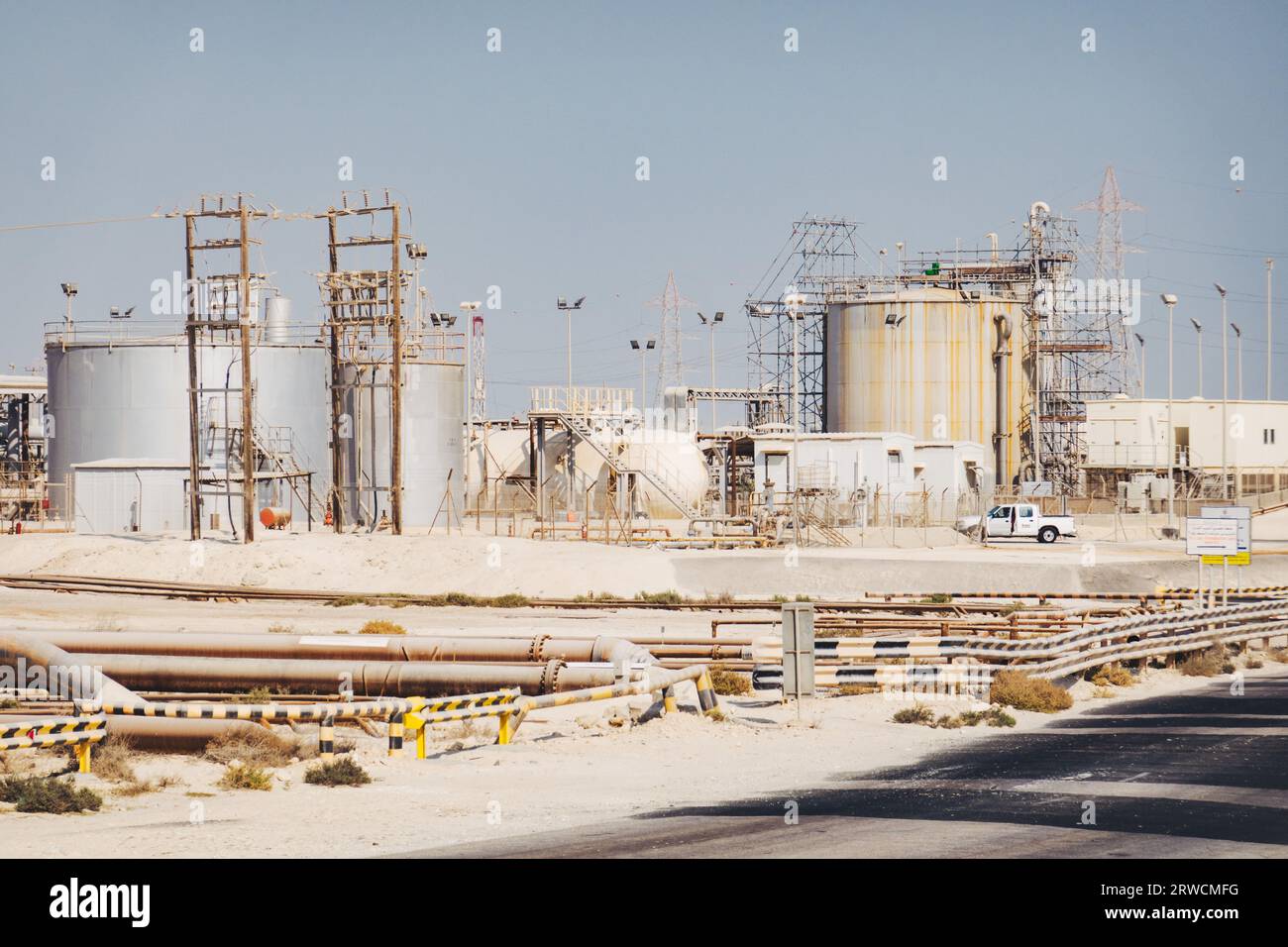 natural gas pipelines, storage tanks and other infrastructure in the desert in Bahrain Stock Photo