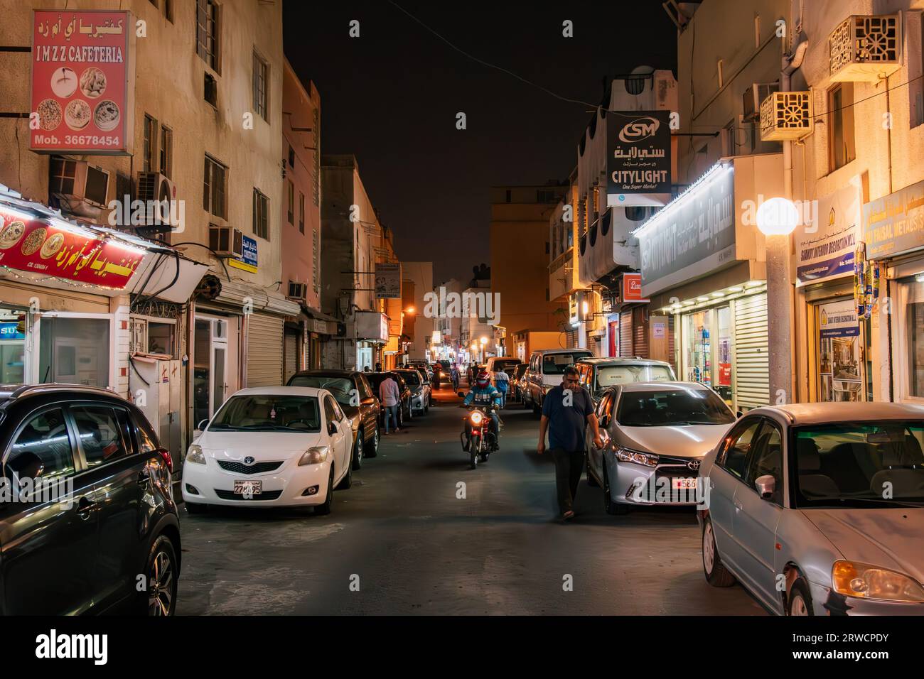a quiet street at night in Manama, Bahrain, on the Pearling Path, a tourist walk following lamp posts through the historic Muharraq neighborhood Stock Photo
