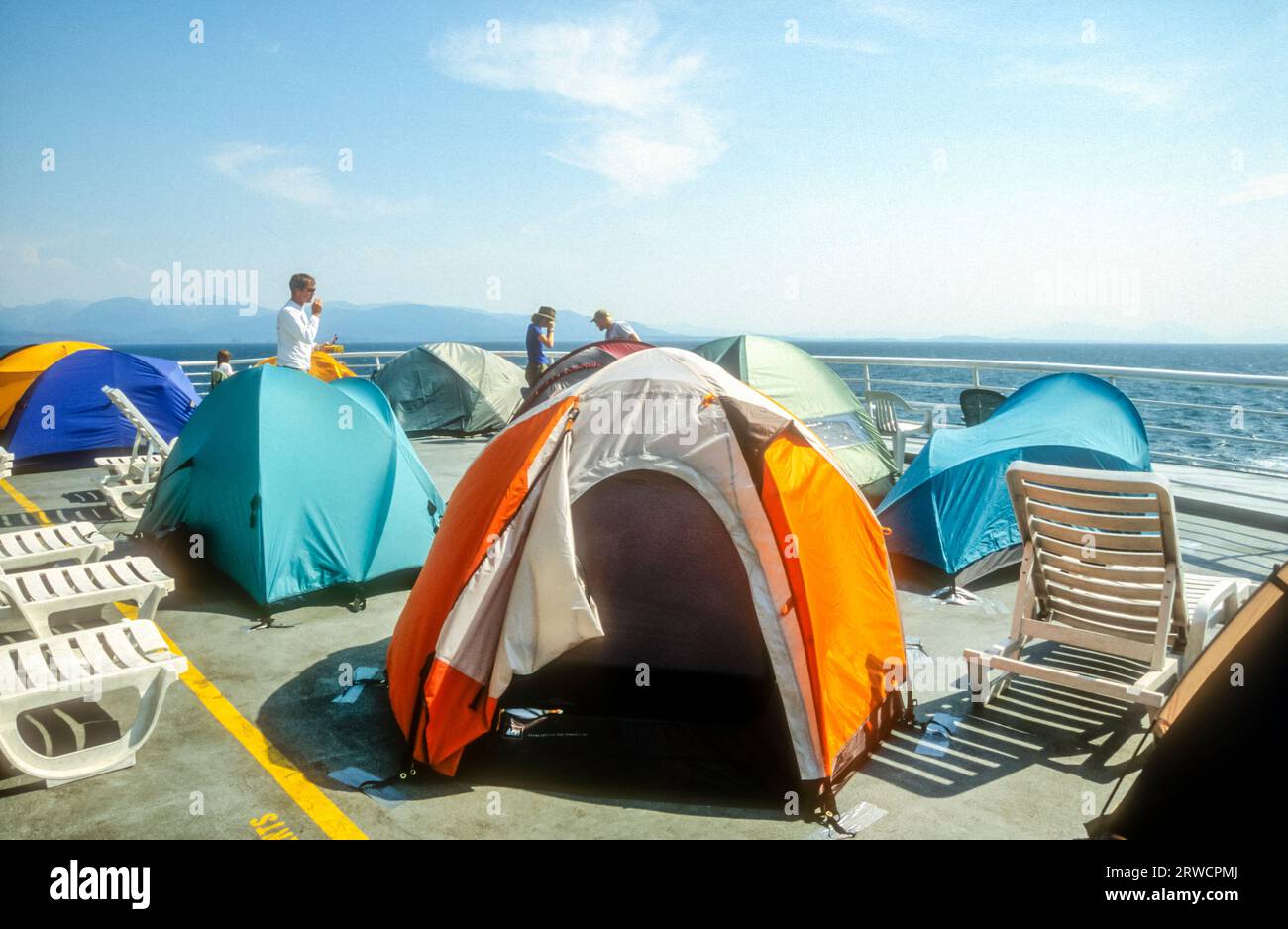 People travelling to Alaska by ferry saving on cost of a cabin by pitching tents on deck.  On MV Columbia. Stock Photo
