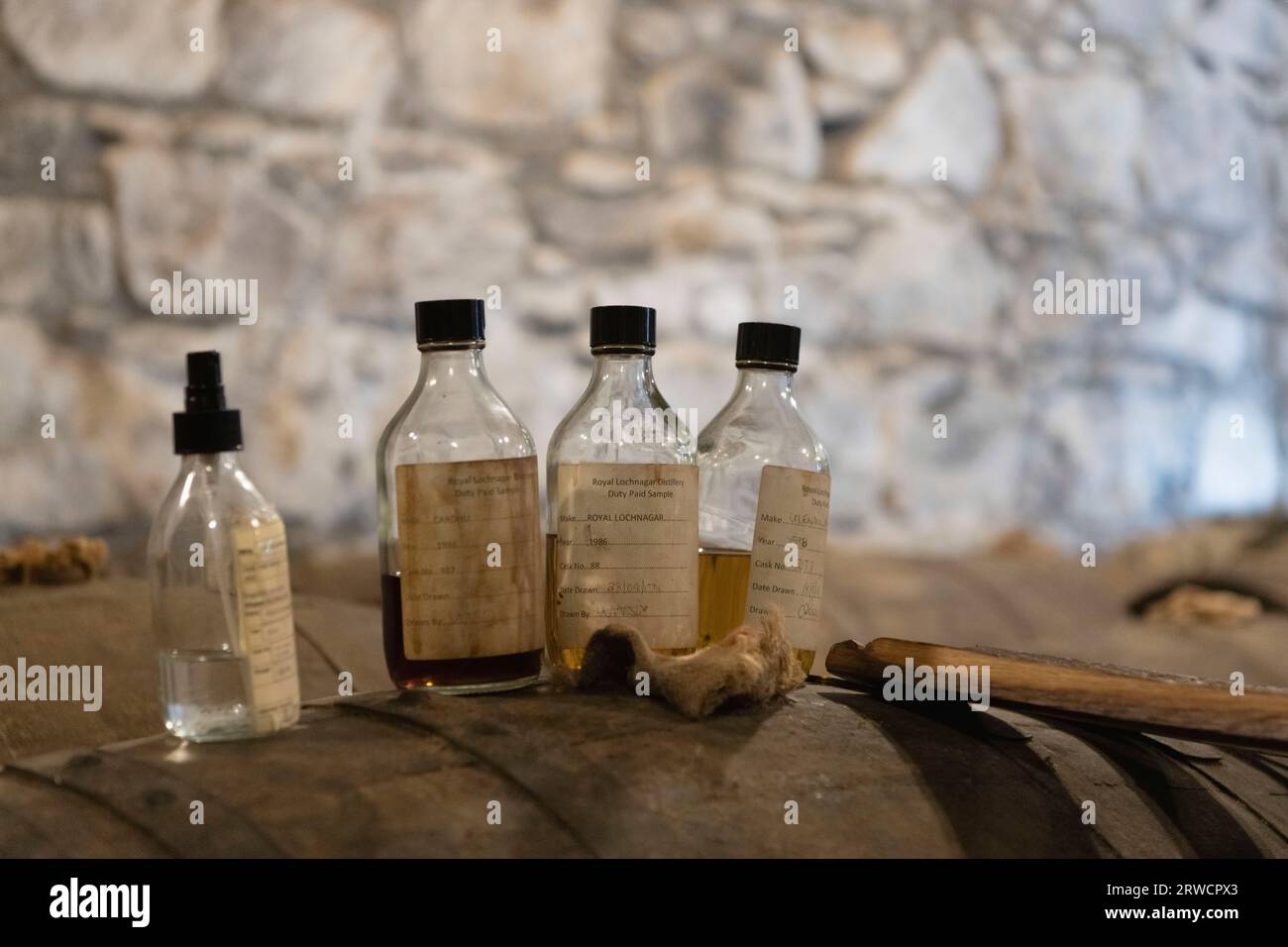 Bottles of Duty Paid Samples of Royal Lochnagar Whisky Displayed on a Cask in a Warehouse During the Distillery Tour on Royal Deeside Stock Photo