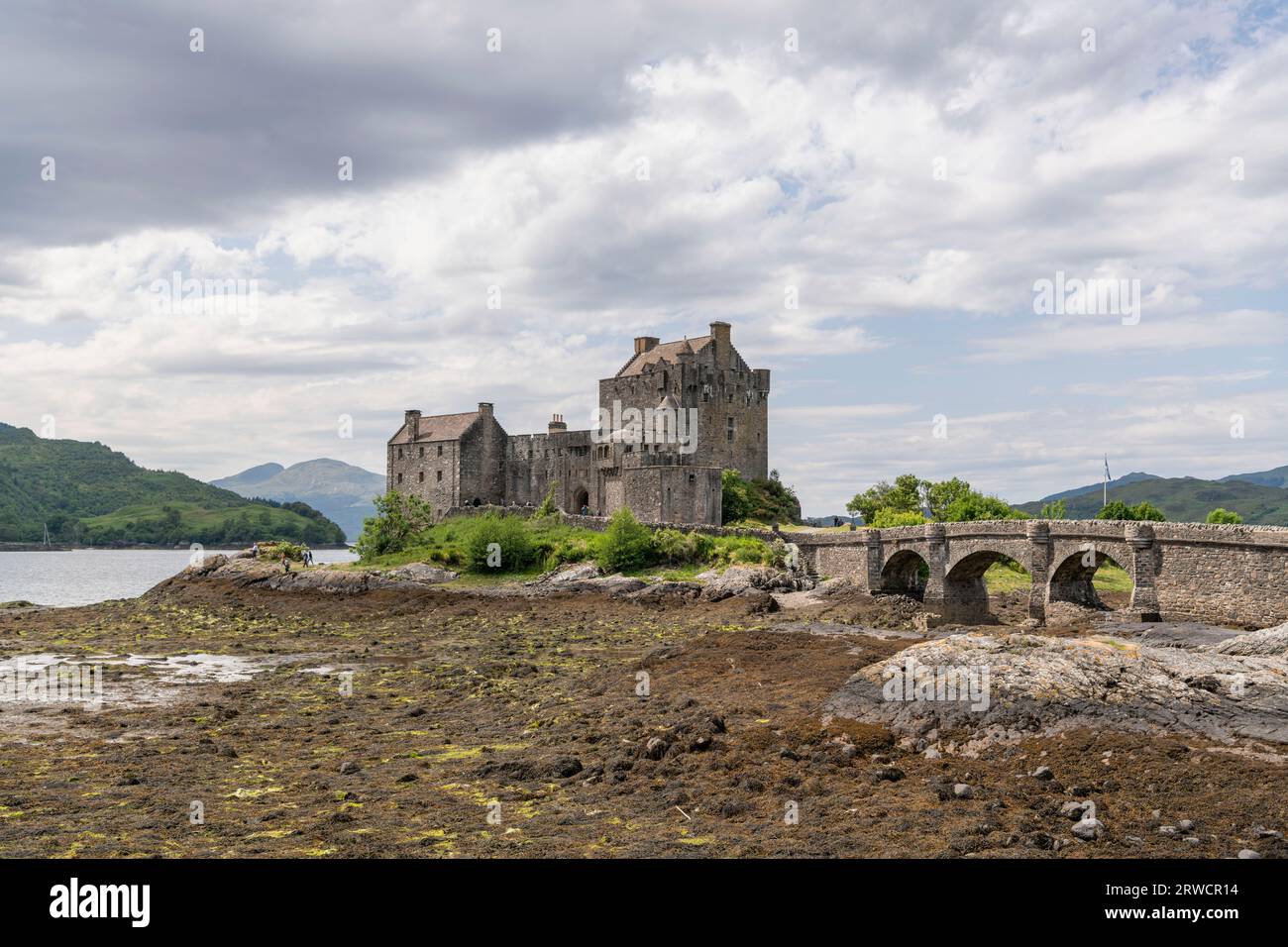 Eilean Donan and the Causeway to the Castle on the Shores of Loch Duich at Low Tide in Summer Stock Photo