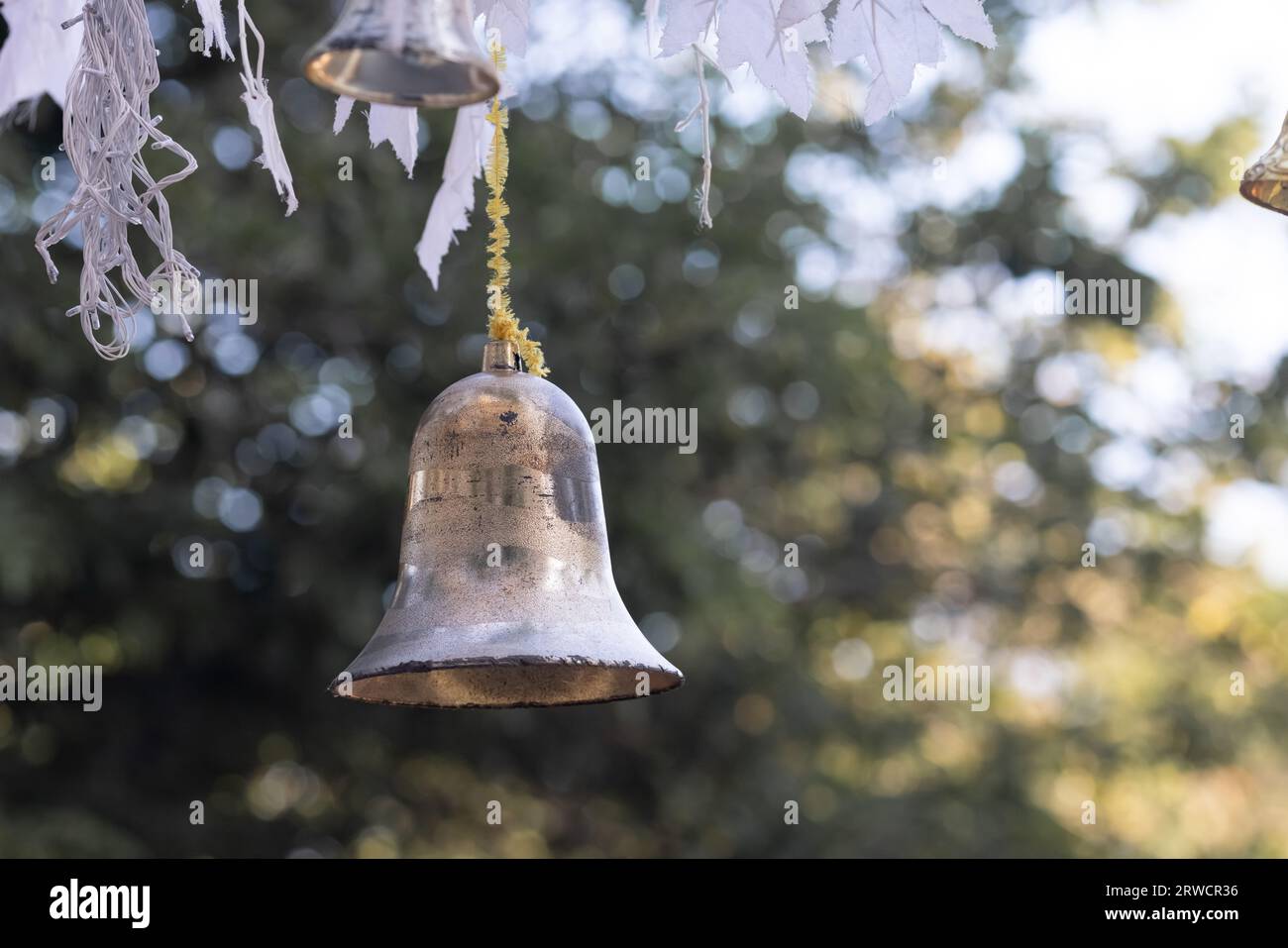 Closeup view of beautiful old fashioned golden christmas bell hanging ...