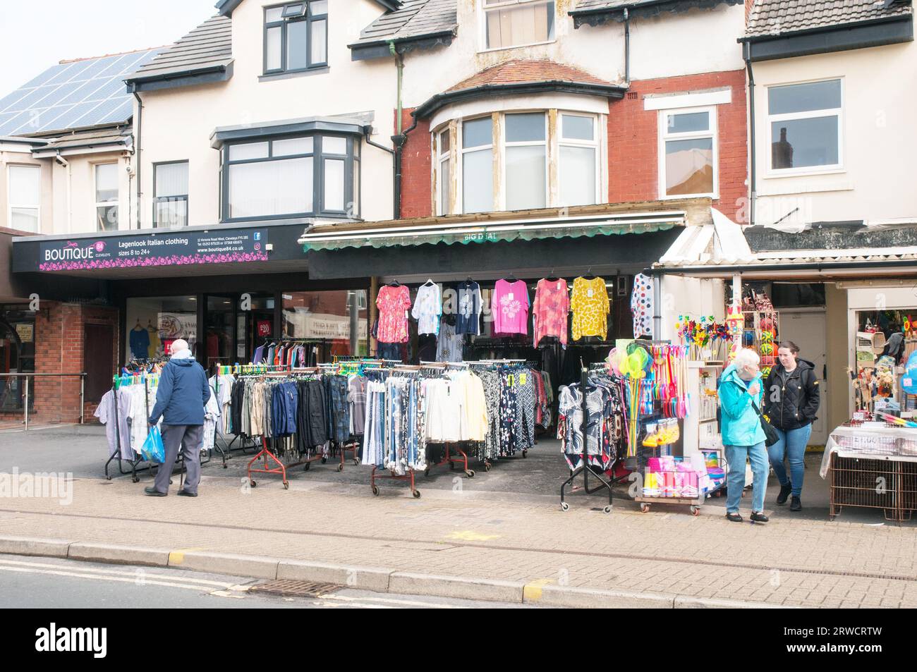 Shirts and other clothing on display for sale outdoor on pedestrian area outside shop in Cleveleys Lancashire England UK Stock Photo