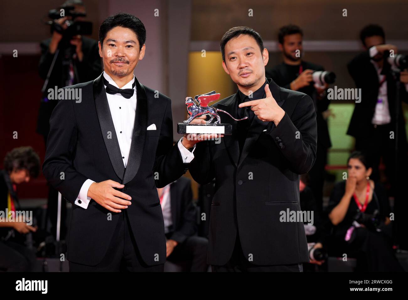 Venice, Italy. 18th Sep, 2023. Hitoshi Omika and Ryusuke Hamaguchi pose with the Silver Lion Grand Jury Prize Award for 'Evil Does Not Exist during attend the winner's photocall at the 80th Venice International Film Festival (Photo by Daniele Cifala/NurPhoto) Credit: NurPhoto SRL/Alamy Live News Stock Photo