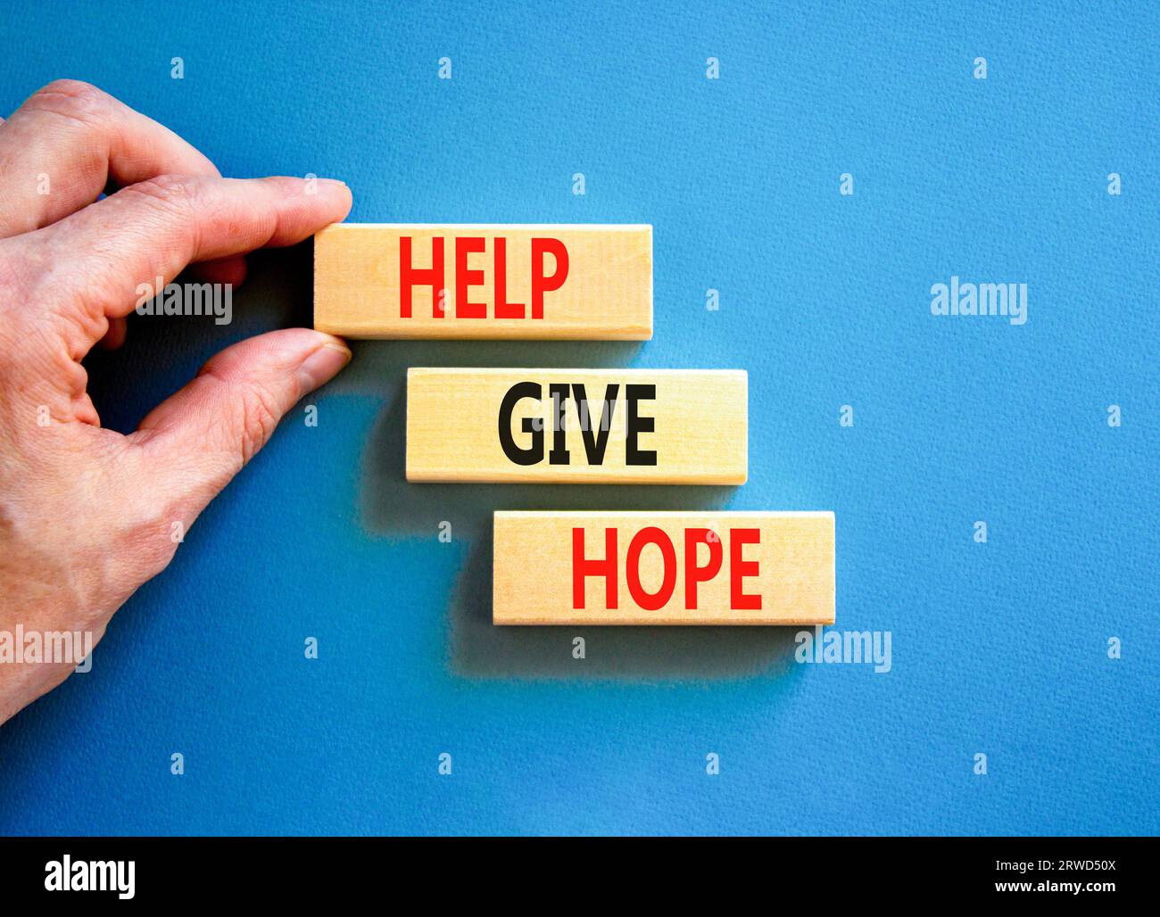 Help give hope symbol. Concept word Help give hope on beautiful wooden ...