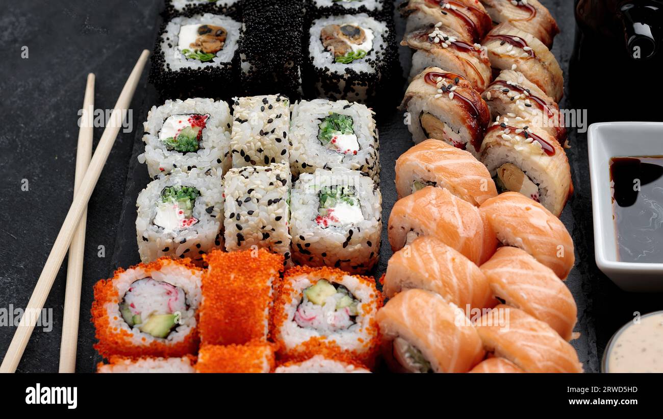 Delectable sushi set with a range of rolls and sauces Stock Photo