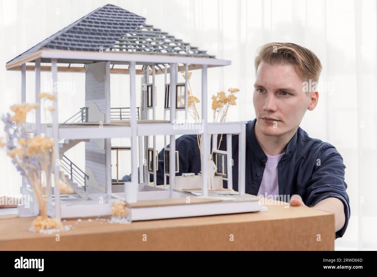 Architect designer reviewing house frame model with no wall, brainstorming interior design and improvement idea with actual home scale. Professional Stock Photo