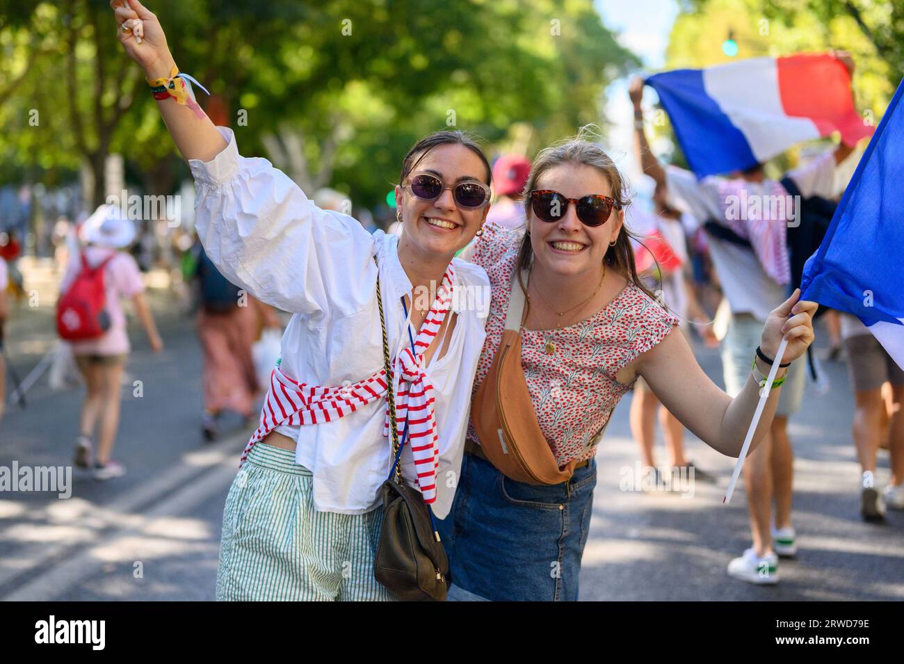 Pilgrims – girls from France – posing for a photo on their way to the opening Holy Mass in Parque Eduardo VII in Lisbon, Portugal. Stock Photo