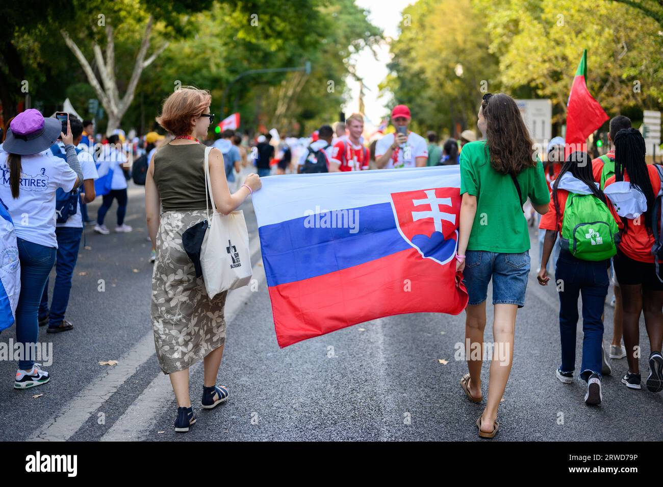 Slovak pilgrims on their way to the opening Holy Mass in Parque Eduardo VII on the first day of World Youth Days 2023 in Lisbon, Portugal. Stock Photo