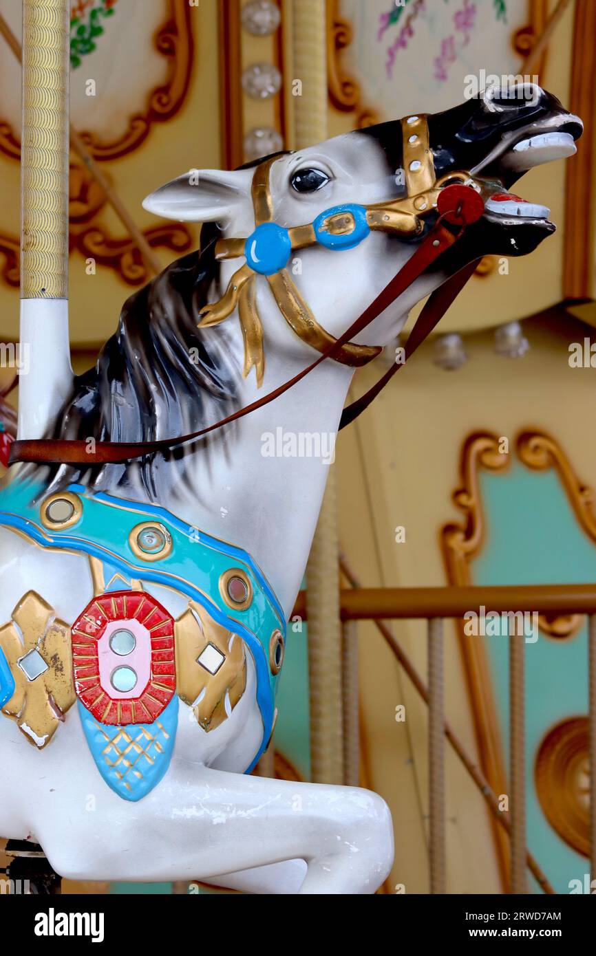 Close up of colourful a traditional fairground galloper carousel horse fitted on a Spanish fairground carousel on the harbour front at La Coruna. Stock Photo