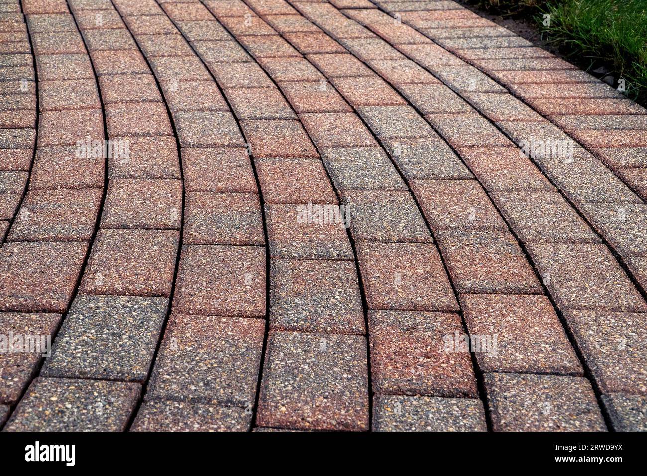 Brick pavers arranged in a curving pattern. Stock Photo