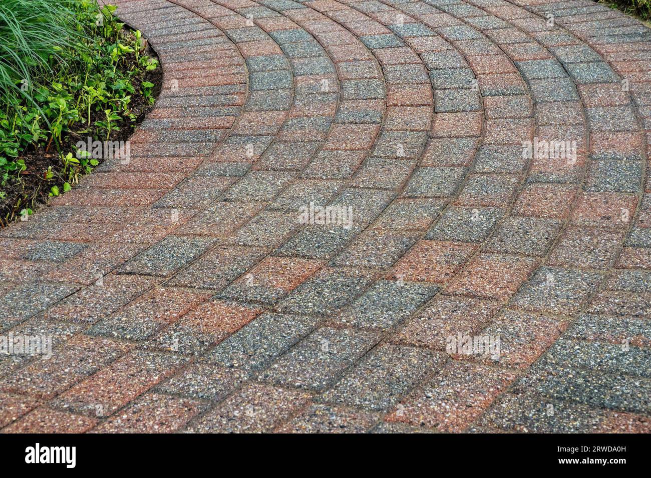 Brick pavers arranged in a curving pattern. Stock Photo
