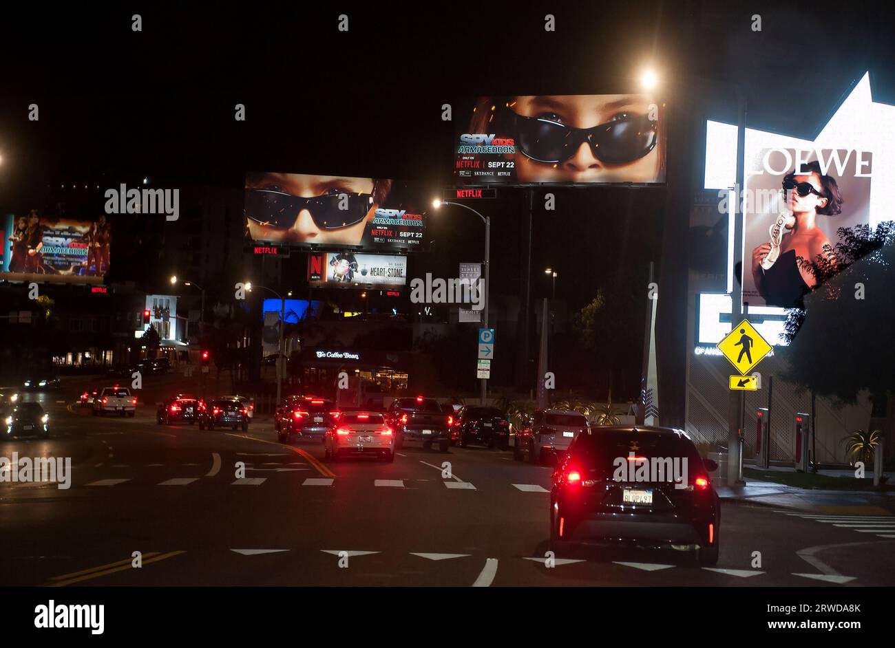 Photo taken through windshield of car driving on the Sunset Strip showing Netflix dominance of the billboards located there in Los Angeles, CA. Stock Photo