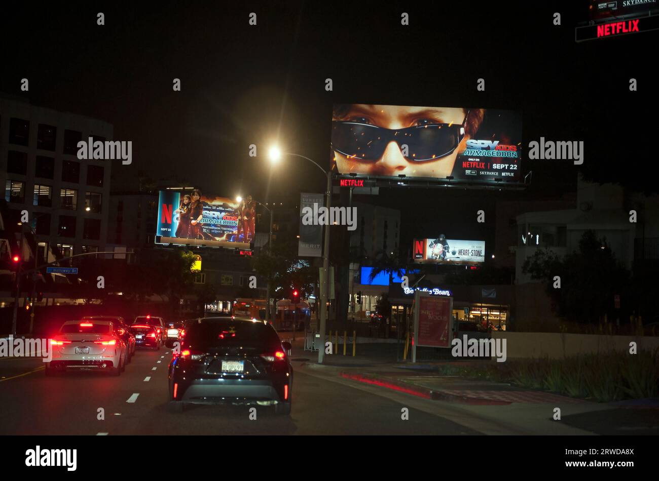Photo taken through windshield of car driving on the Sunset Strip showing Netflix dominance of the billboards located there in Los Angeles, CA. Stock Photo