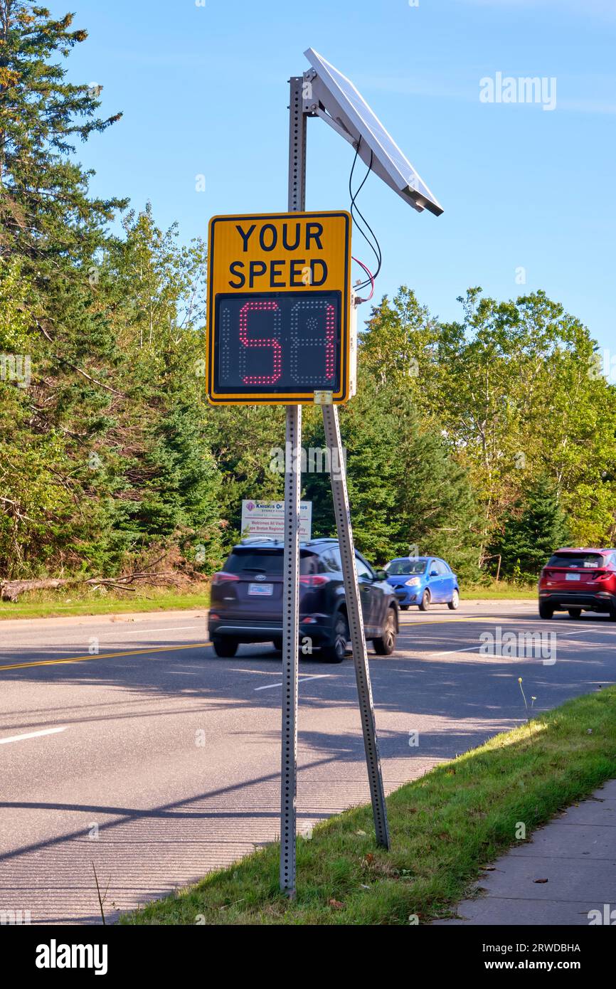 Sign on a busy road that indicates to drivers their speed in an attempt to prevent speeding. Stock Photo