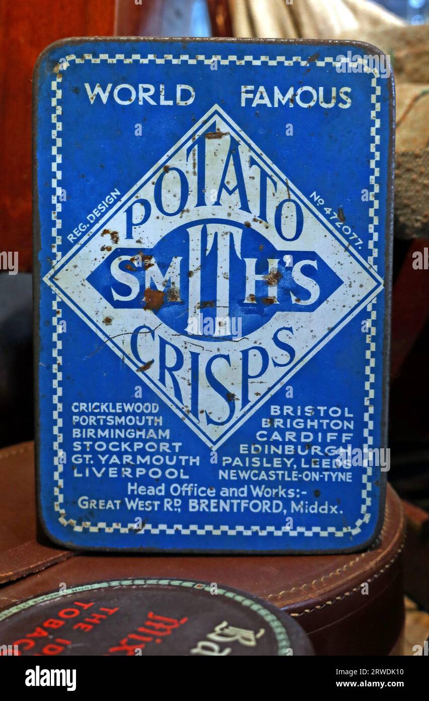 Blue antique tin for world famous British Smiths potato crisps, head office and works :- Great West Road, Brentford, Middlesex, England, UK, TW8 9GU Stock Photo