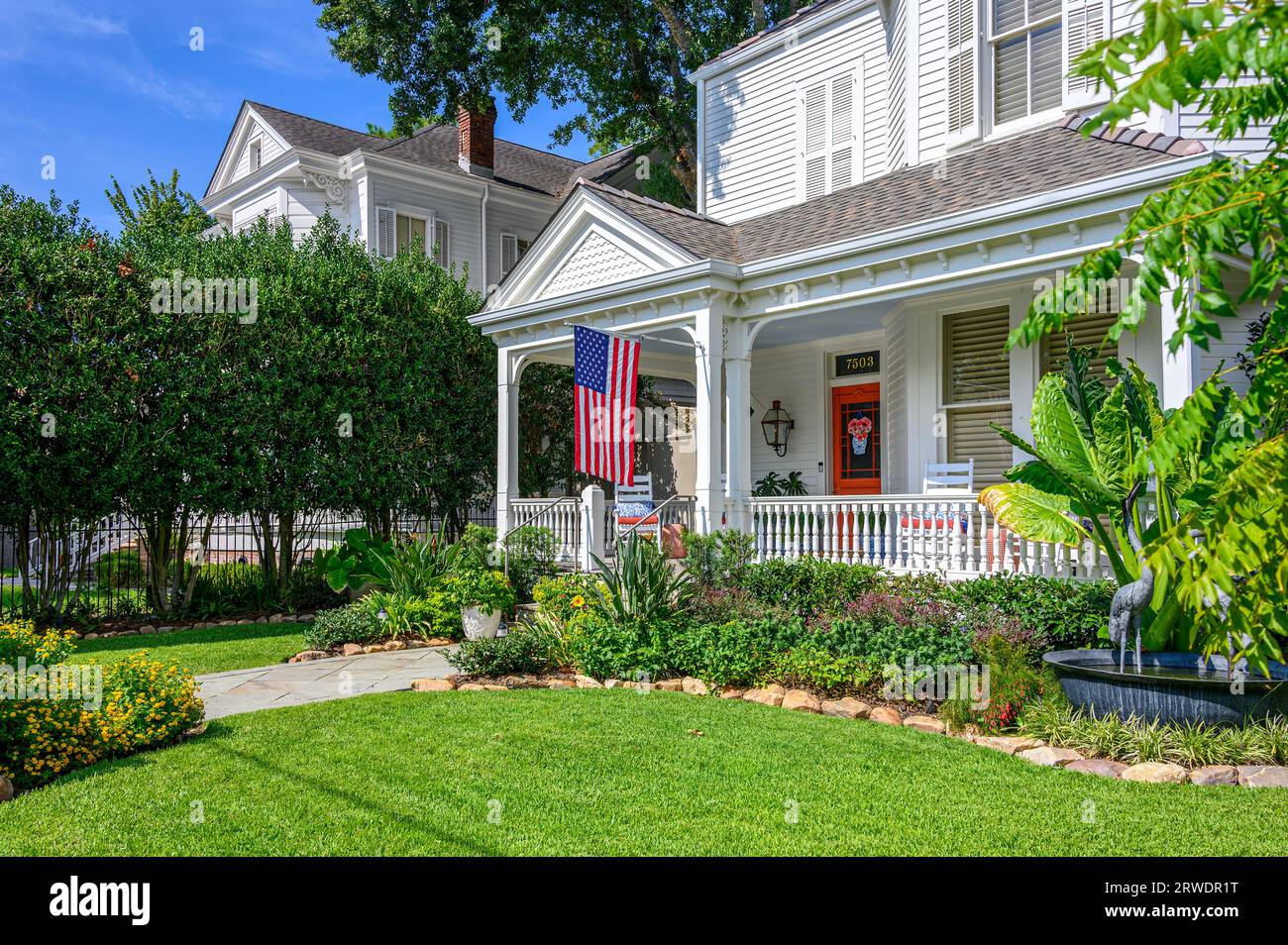 NEW ORLEANS, LA, USA - SEPTEMBER 15, 2023: Front lawn and porch of charming two-story home in Uptown neighborhood Stock Photo