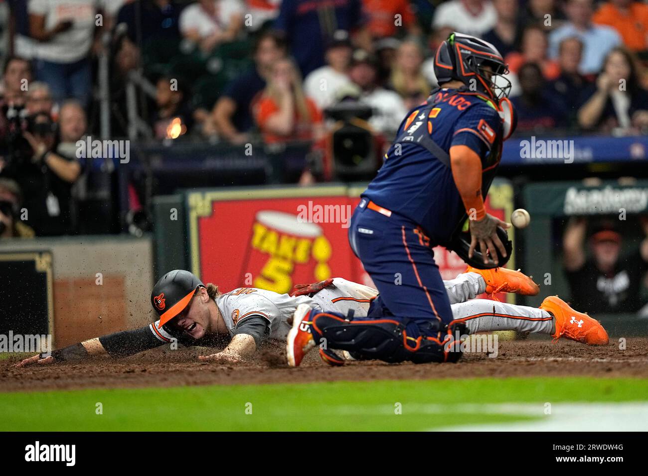 Baltimore Orioles' Gunnar Henderson, rear, scores as Houston Astros ...