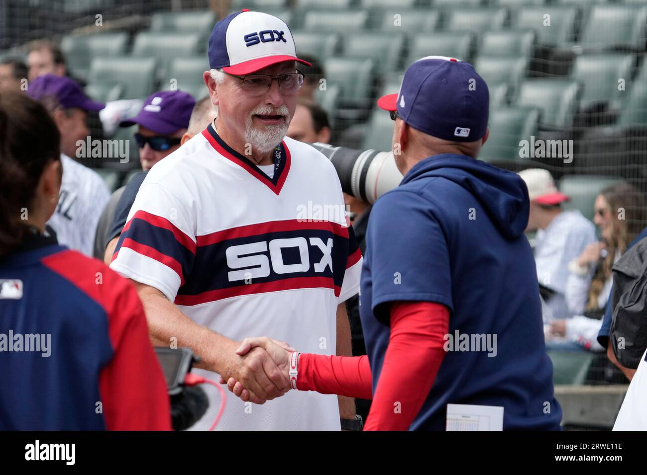 Former Chicago White Sox player Ron Kittle, left, shakes hands with manager  Pedro Grifol before a baseball game against the Minnesota Twins in Chicago,  Sunday, Sept. 17, 2023. (AP Photo/Nam Y. Huh