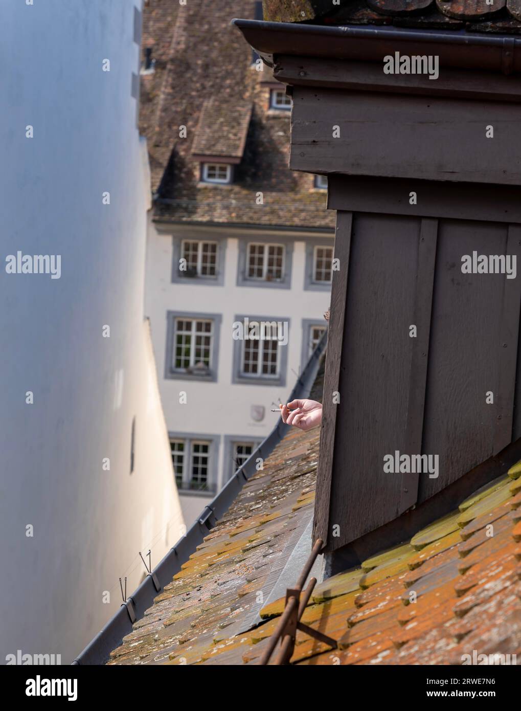 Hand Holding a Cigarette From Roof Window in Schaffhausen, Switzerland ...