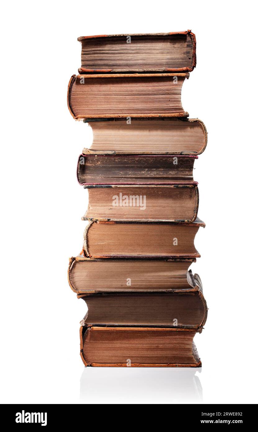 A Stack of old books isolated on white with natural reflection Stock Photo