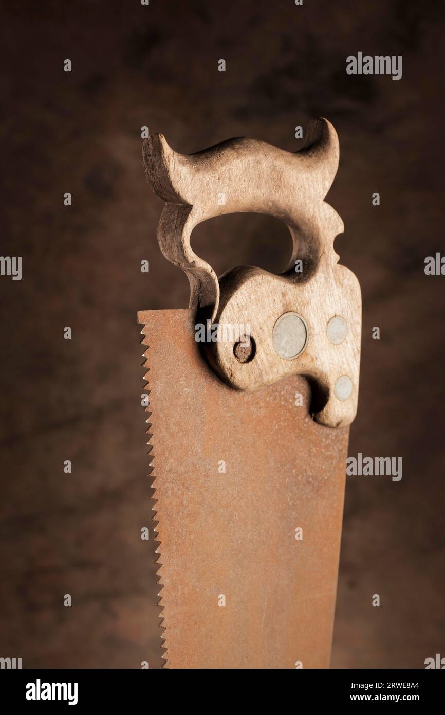 Wooden handle of an old rusty saw Stock Photo
