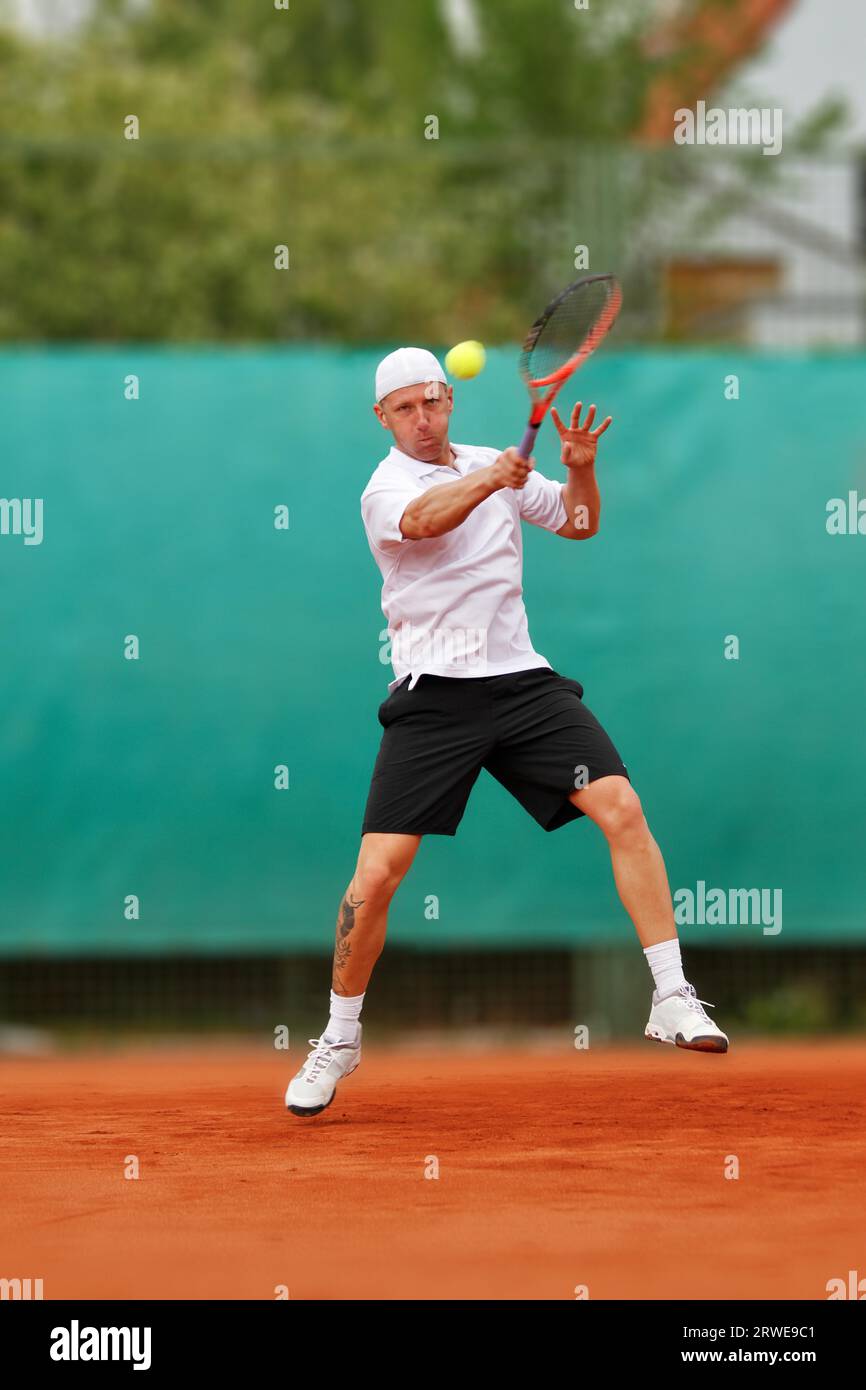 Tennis player hits topspin forehand Stock Photo Alamy