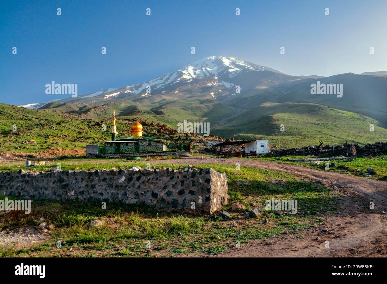 Mosque underneath volcano Damavand, highest peak in Iran Stock Photo