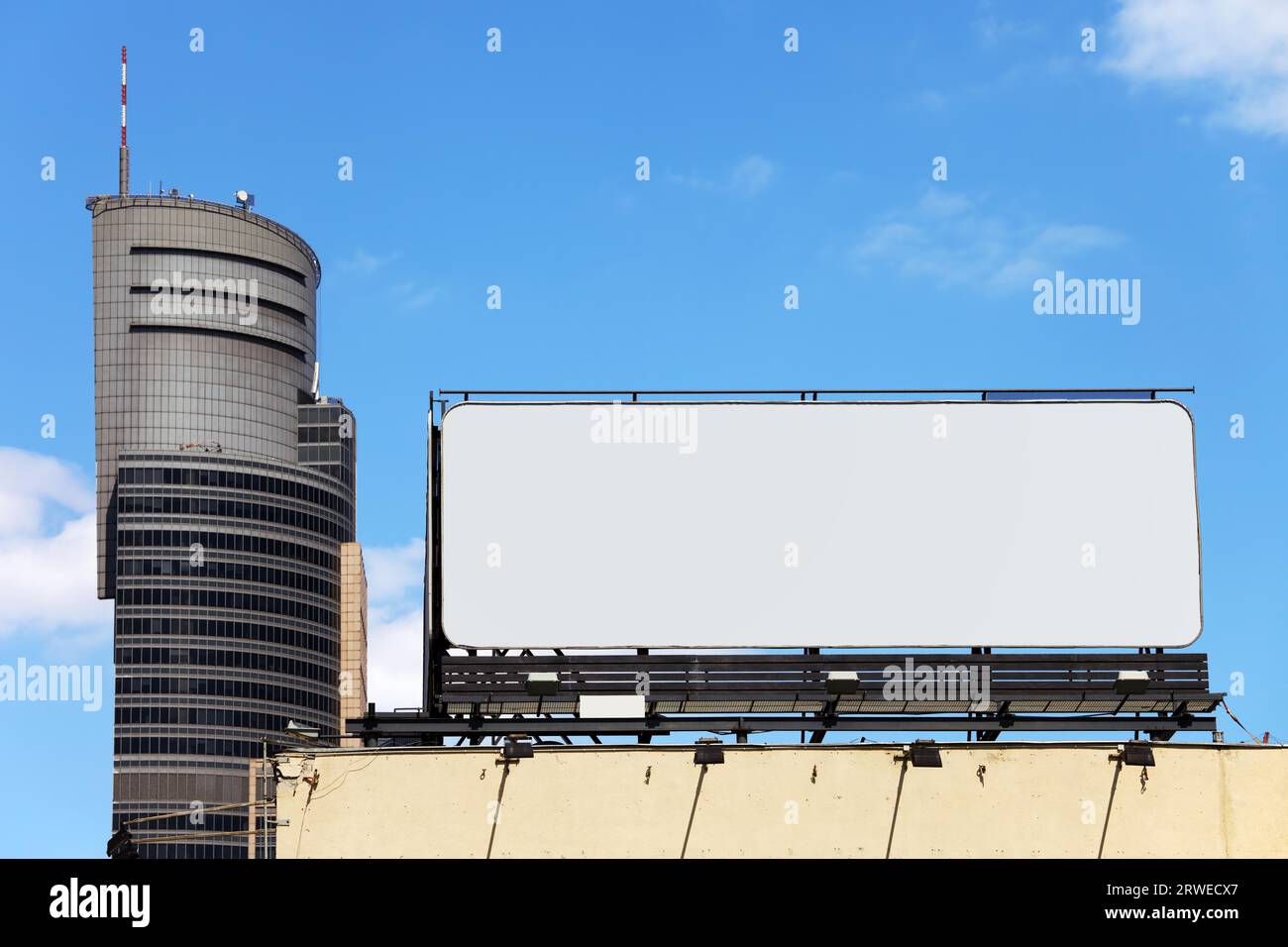 Large blank billboard on a building roof in the city downtown Stock Photo