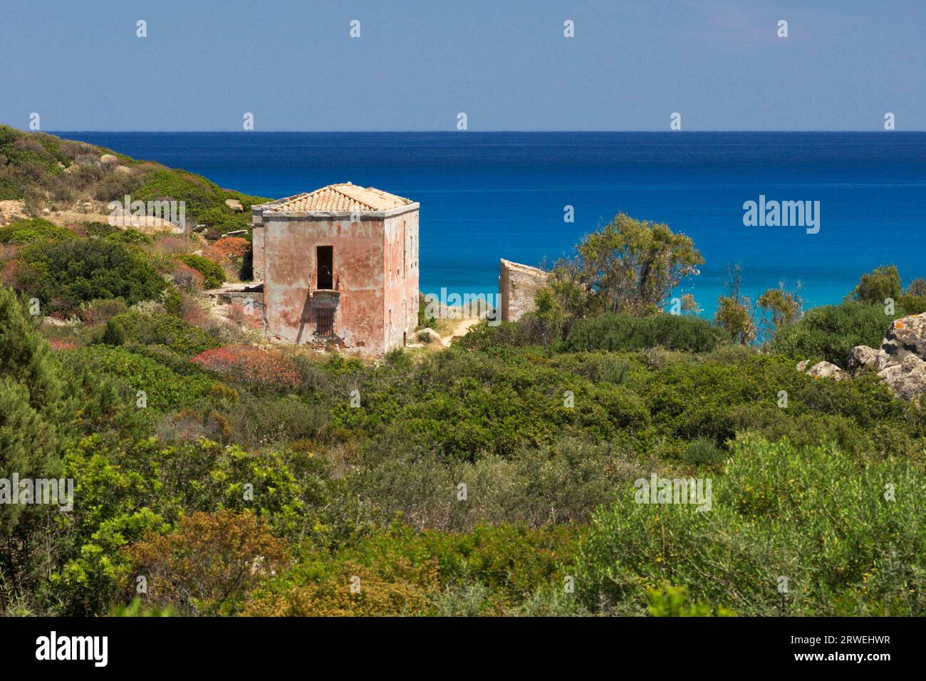 Dilapidated house on the beach near Villasimius Stock Photo