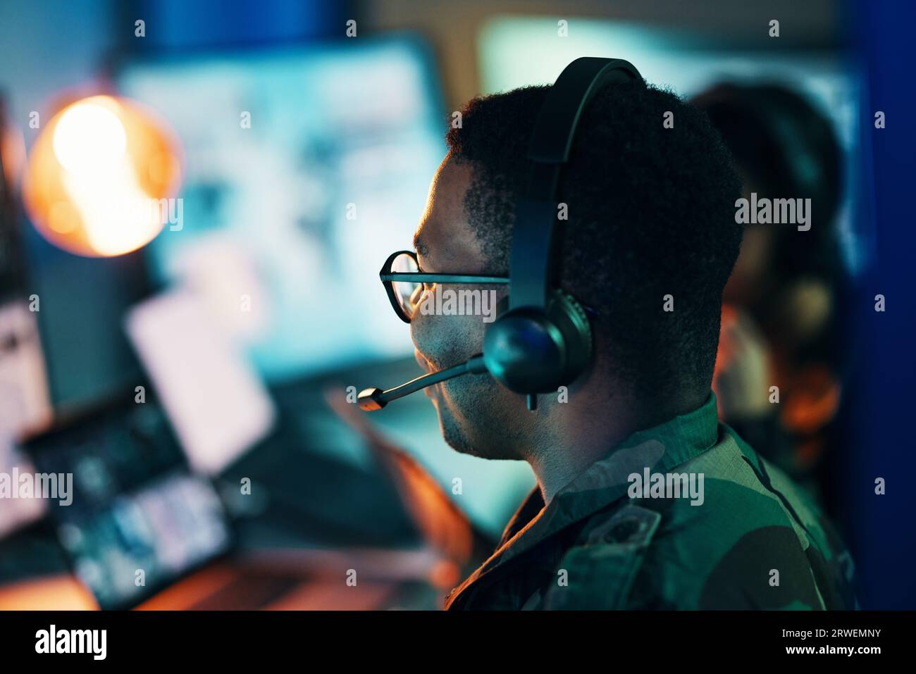 Military control room, computer and man and surveillance from back, tech and communication at desk. Security, global and soldier in army office at Stock Photo